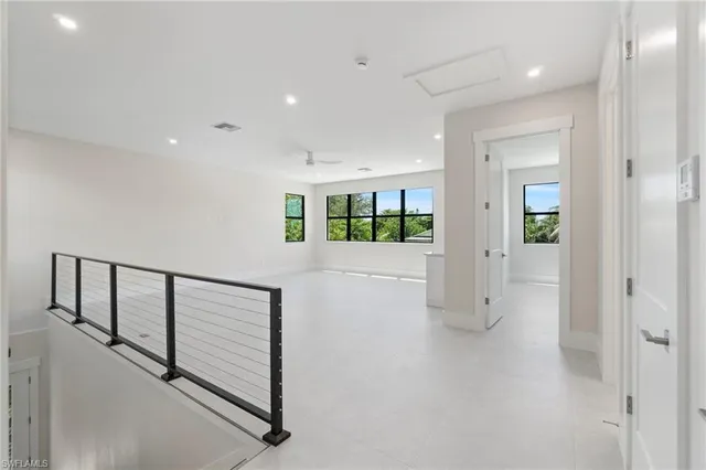 a view of a hallway with wooden floor and entryway
