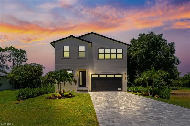 a front view of a house with a yard and garage