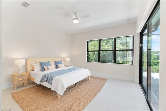 a bedroom with a large bed and a large window