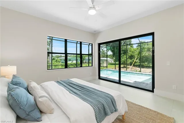 a bedroom with a large bed and a large window