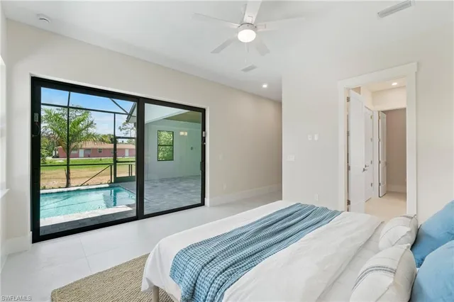 a bedroom with a large bed and a large window