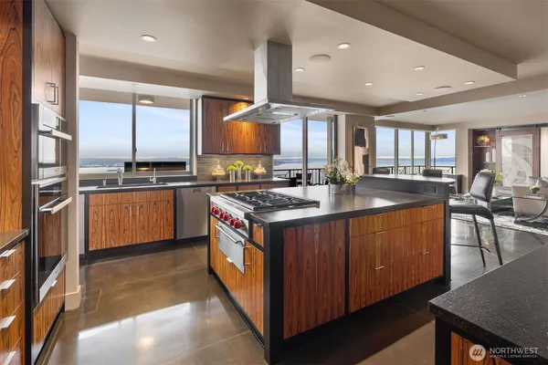 a kitchen with stainless steel appliances granite countertop a sink stove and refrigerator