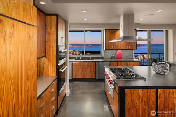 a view of a living room with furniture and floor to ceiling windows