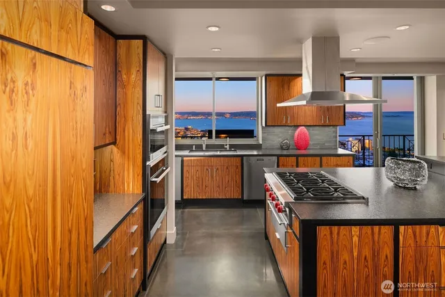 a view of a living room with furniture and floor to ceiling windows