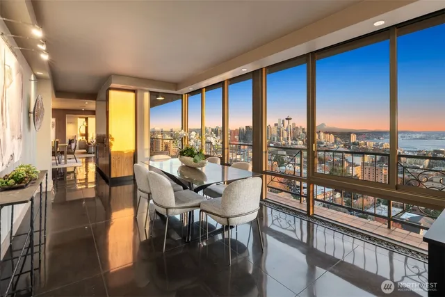 a dining room with furniture a chandelier and wooden floor