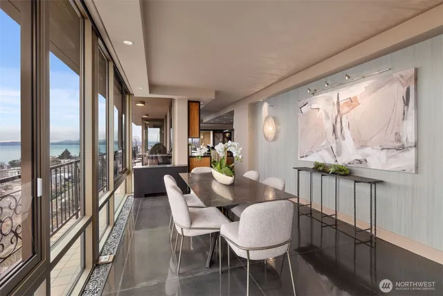 a view of a dining room with furniture large windows and wooden floor