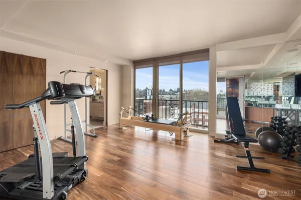a spacious bedroom with a bed couch and a large window