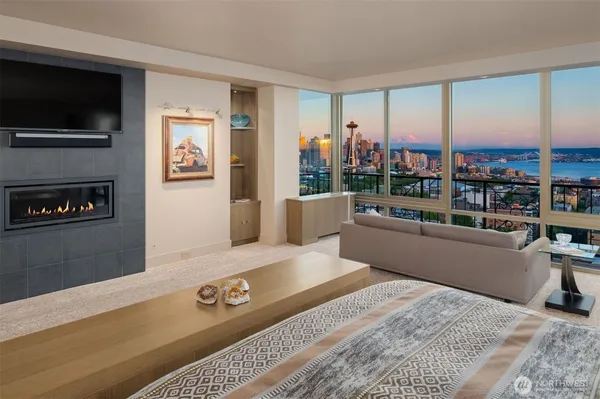 a living room with kitchen island granite countertop furniture and a chandelier