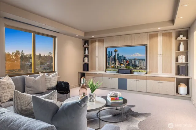 a living room with furniture and a floor to ceiling window