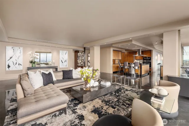 a living room with furniture and a floor to ceiling window