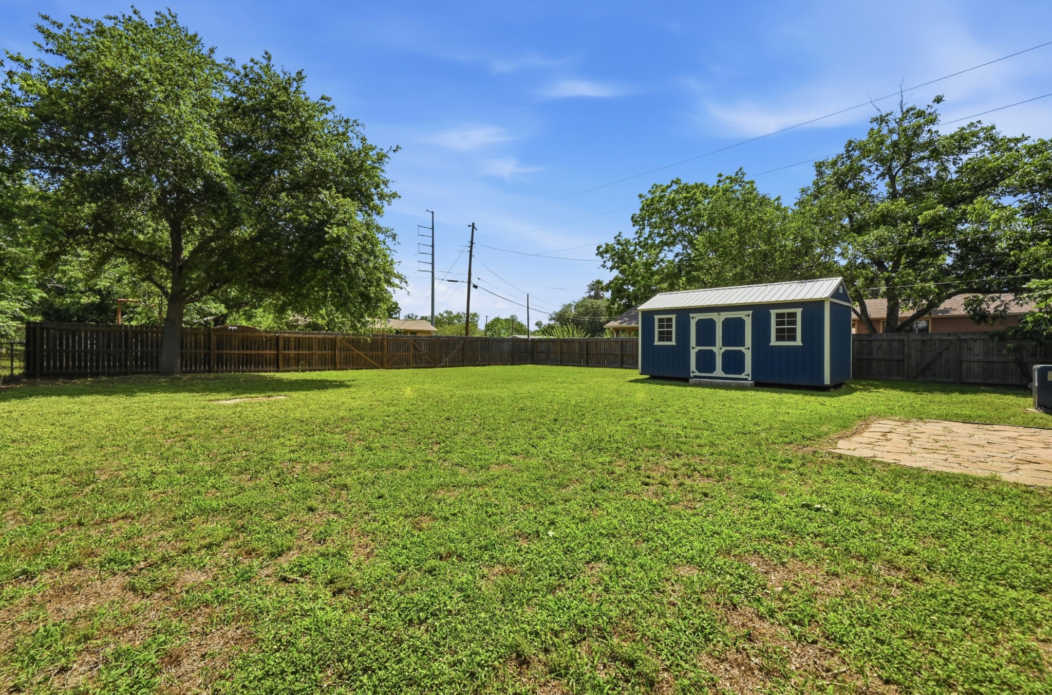 1127 Parr Street Luling, TX 78648 - Photo 16 of 20 A spacious, fenced backyard offers a detached storage shed for ample utility.