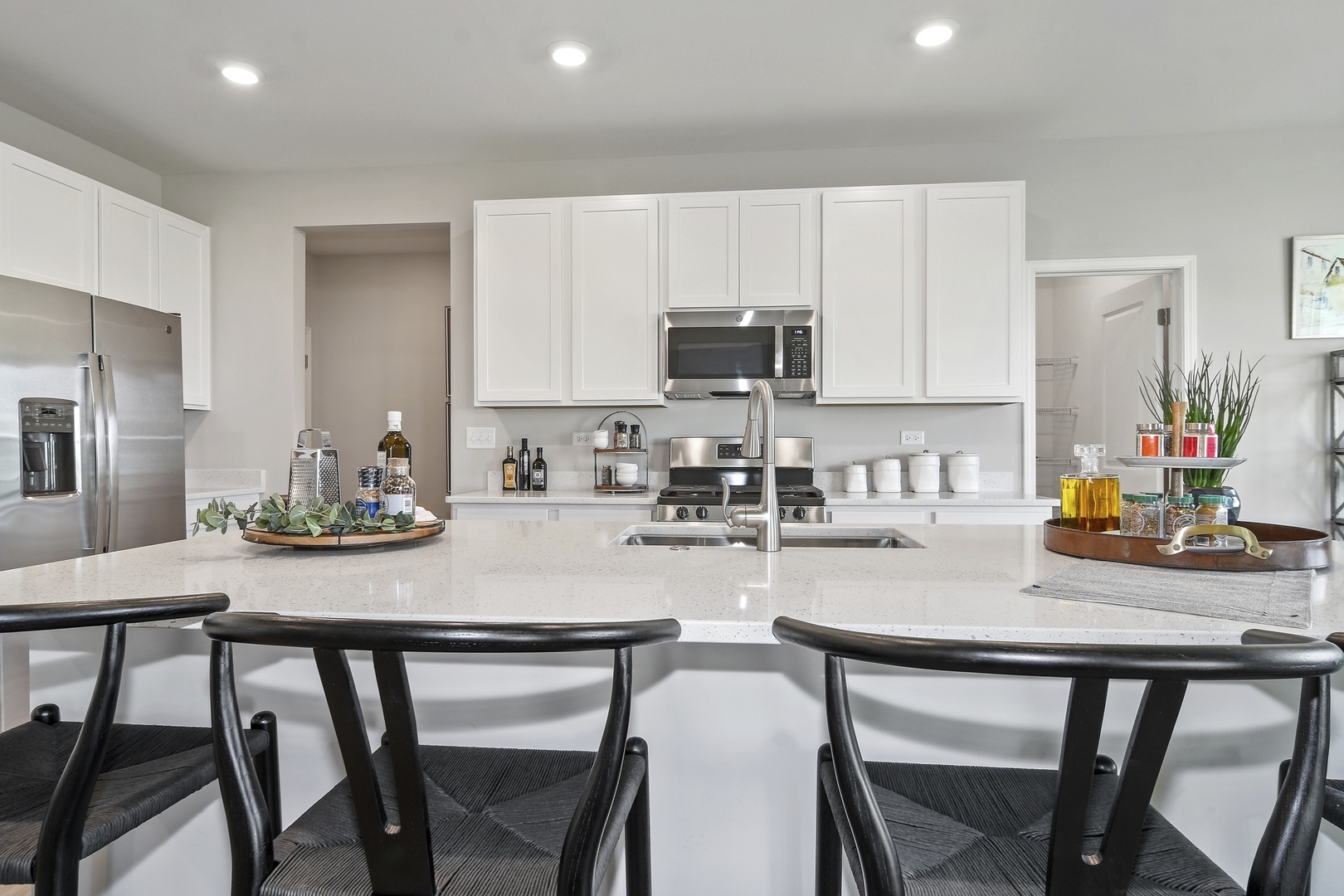 16249 Longcommon Lane Plainfield, IL 60586 - Photo 4 of 27 a kitchen with kitchen island a table and chair in it