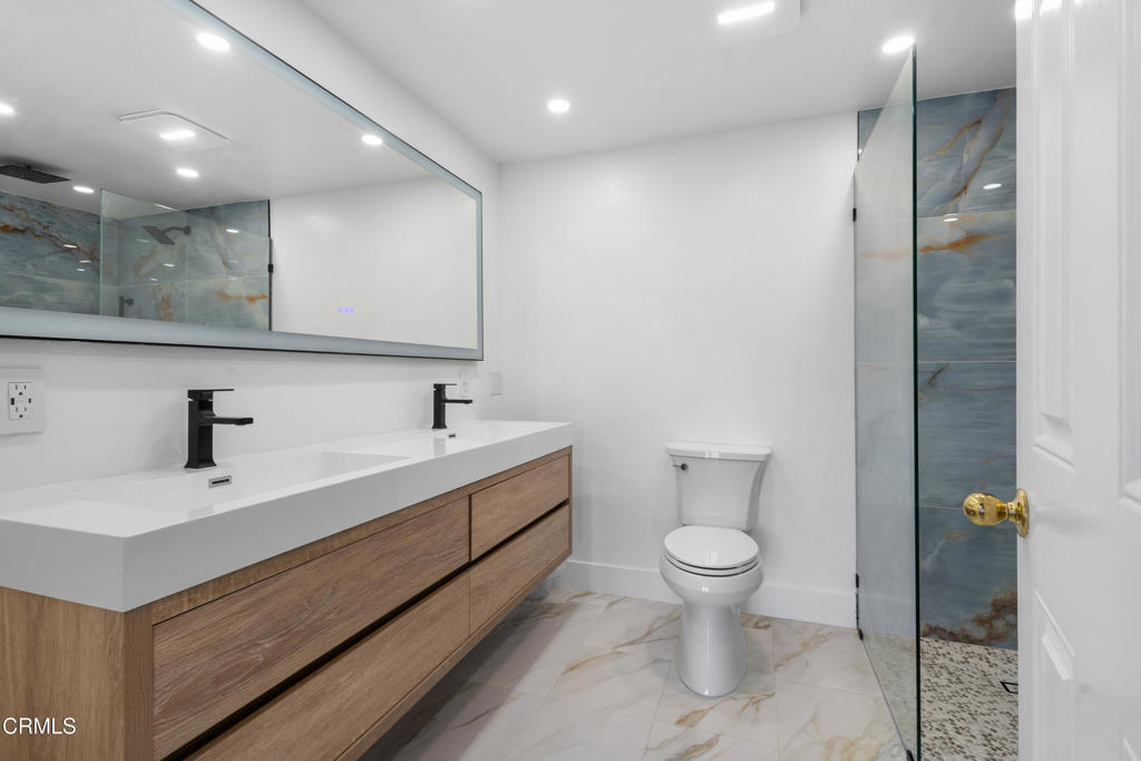 3960 West Hemlock Street Oxnard, CA 93035 - Photo 17 of 42 a bathroom with a toilet sink and mirror