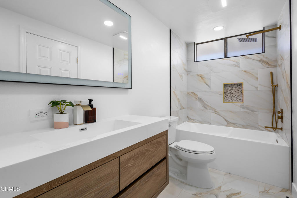 3960 West Hemlock Street Oxnard, CA 93035 - Photo 23 of 42 a bathroom with a sink a toilet and a bathtub