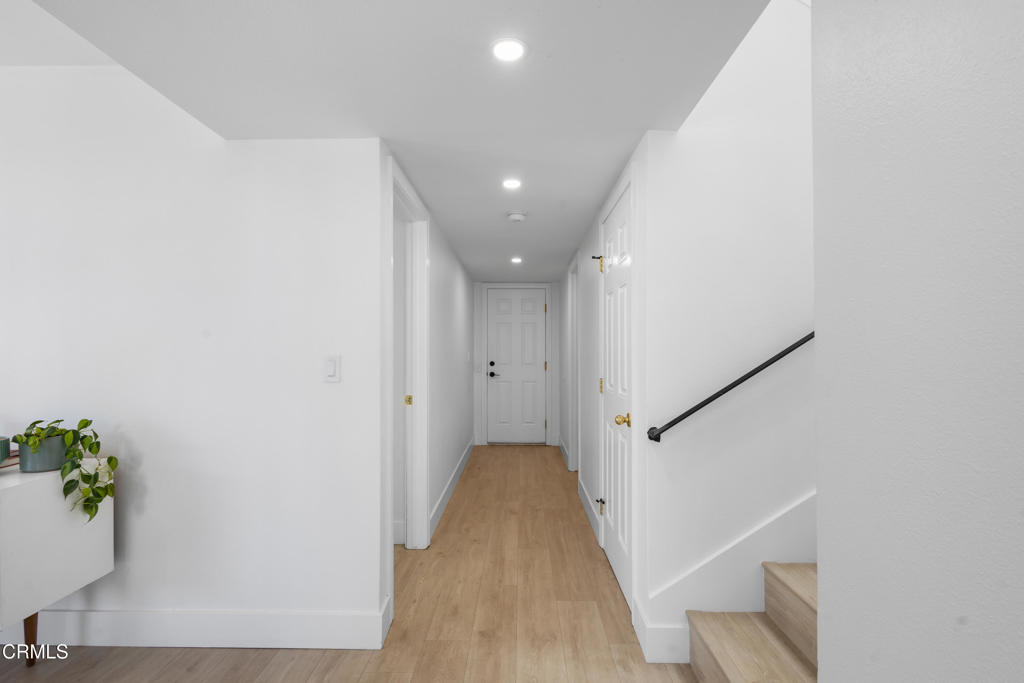 3960 West Hemlock Street Oxnard, CA 93035 - Photo 38 of 42 a view of a hallway with wooden floor and stairs