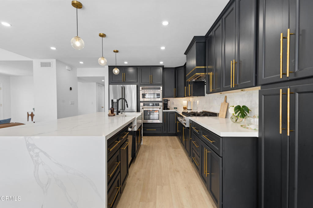 3960 West Hemlock Street Oxnard, CA 93035 - Photo 10 of 42 a kitchen with stainless steel appliances granite countertop lots of counter top space a sink and cabinets