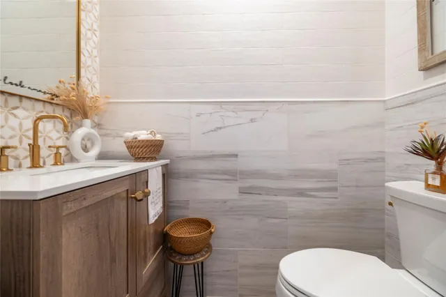 a bathroom with a sink a toilet and mirror