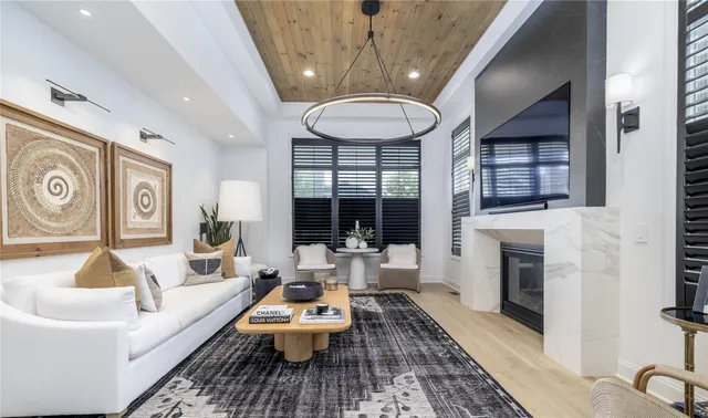 a living room with fireplace furniture and a large window
