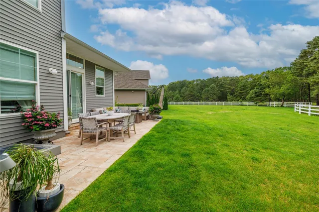 a view of a backyard with sitting area