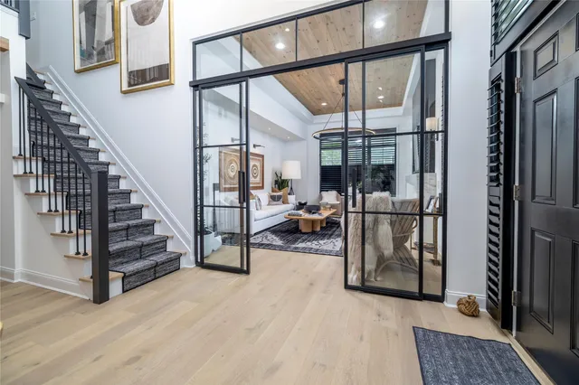 a view of staircase and living room with wooden floor and windows