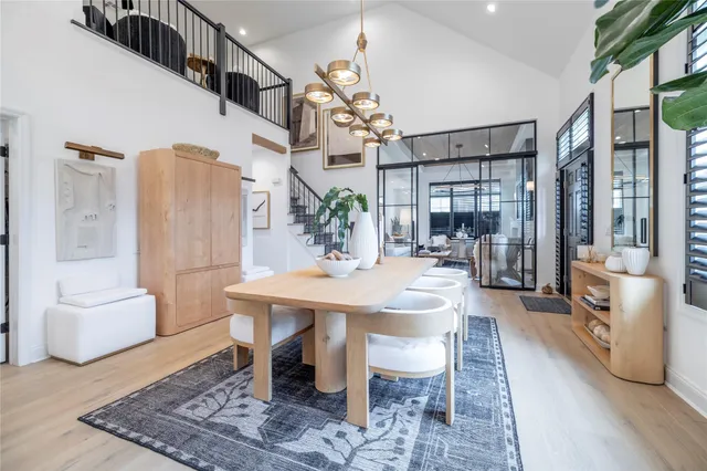 a view of a dining room with furniture and a chandelier