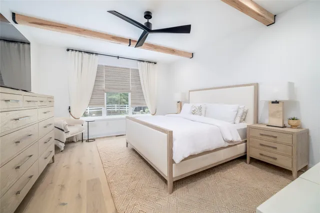 a spacious bedroom with a bed and a window