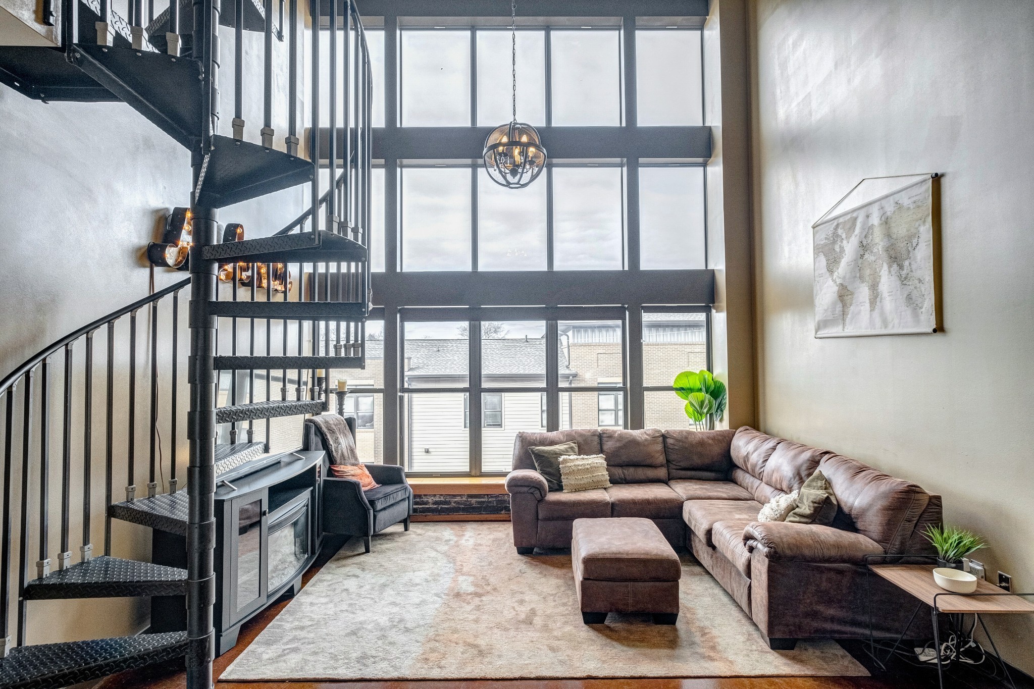 a living room with furniture fireplace and a window