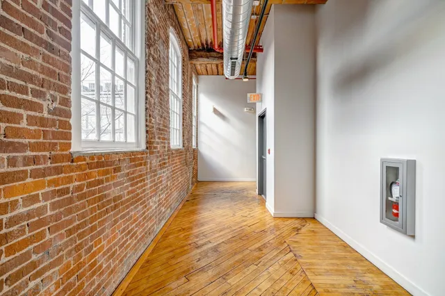 a view of hallway with a large window and entryway