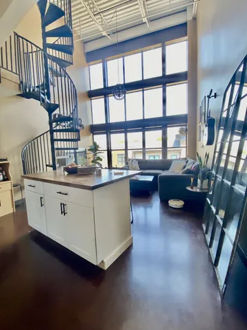 a living room with furniture wooden floor and a book shelf