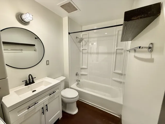 a bathroom with a sink toilet and shower