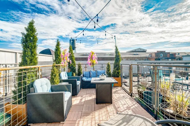 a view of roof deck with furniture