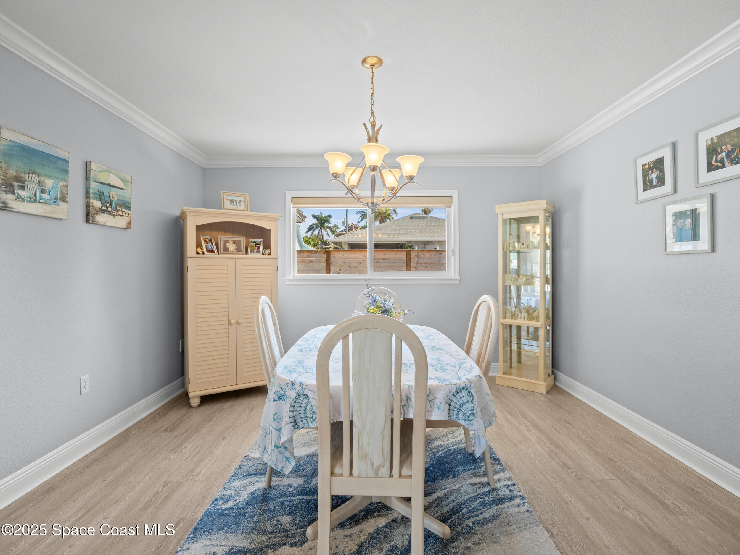 230 Riggs Avenue Melbourne Beach, FL 32951 - Photo 12 of 38 a view of a dining room with furniture window and wooden floor