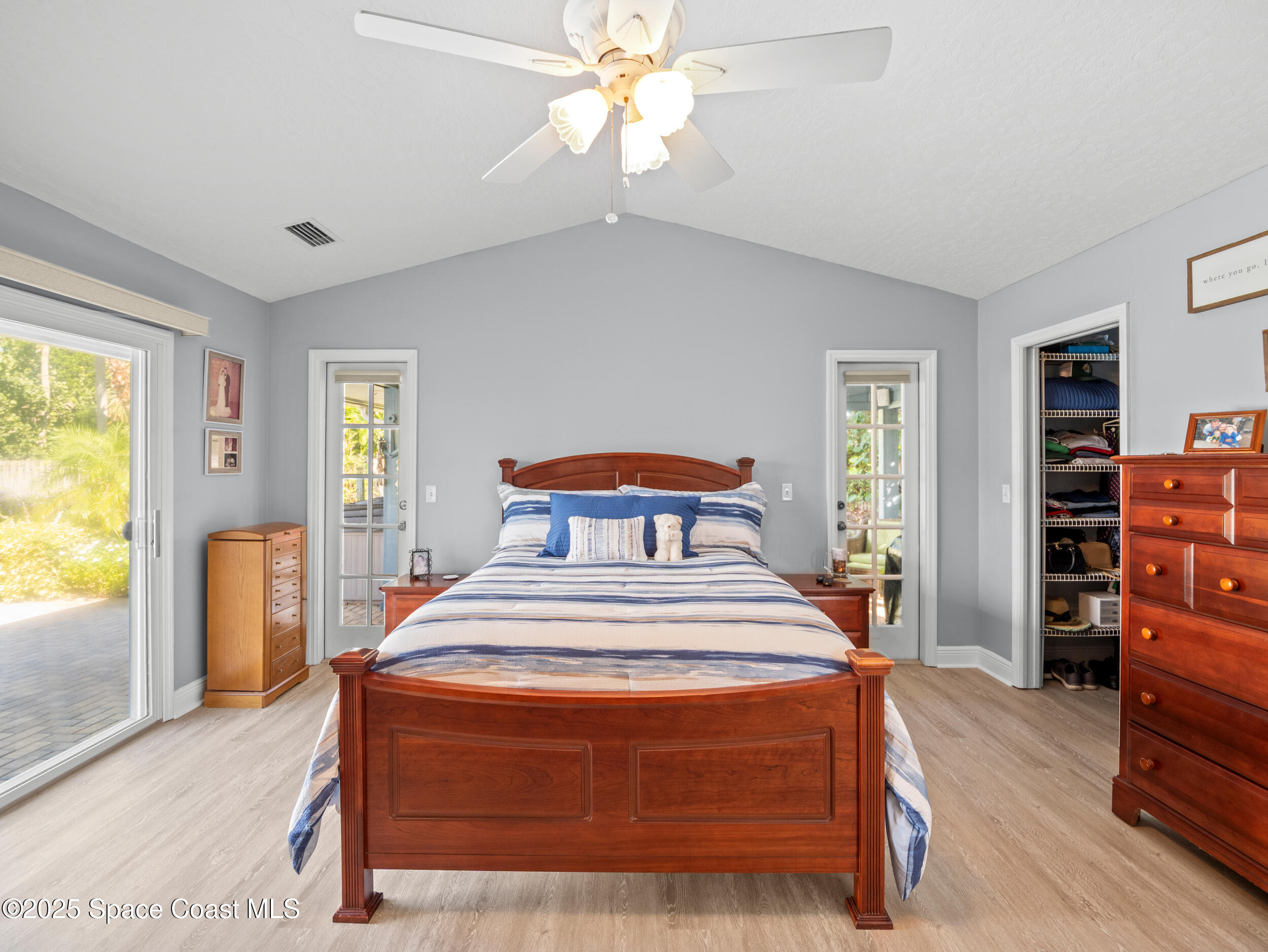 230 Riggs Avenue Melbourne Beach, FL 32951 - Photo 15 of 38 a spacious bedroom with a bed and wooden floor