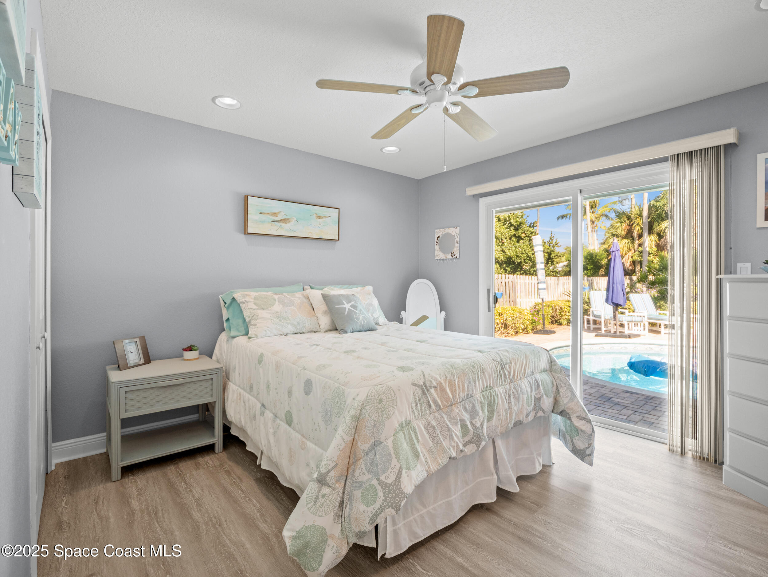 230 Riggs Avenue Melbourne Beach, FL 32951 - Photo 18 of 38 a bedroom with a bed and a large window
