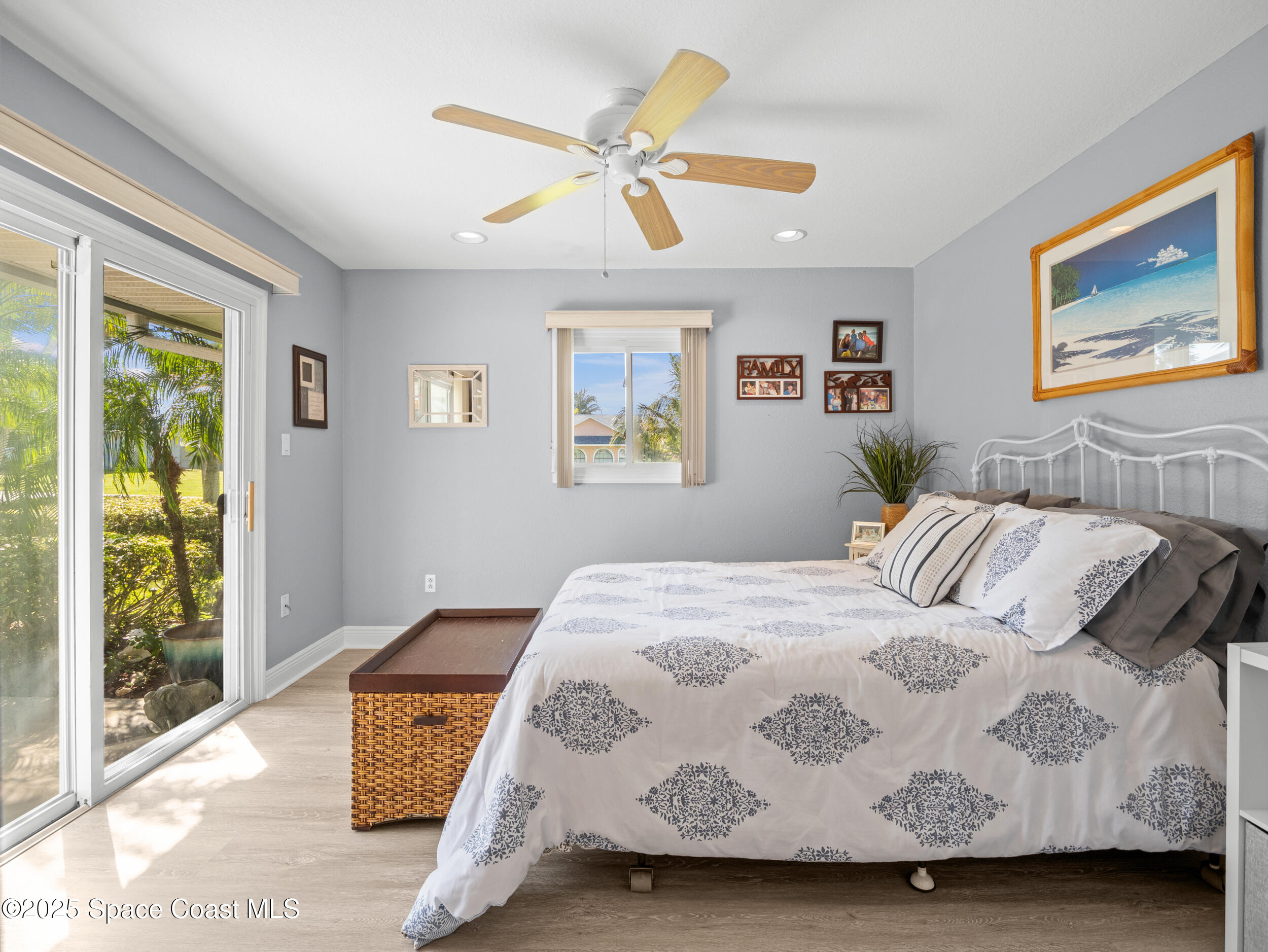 230 Riggs Avenue Melbourne Beach, FL 32951 - Photo 19 of 38 a bedroom with a bed and a large window