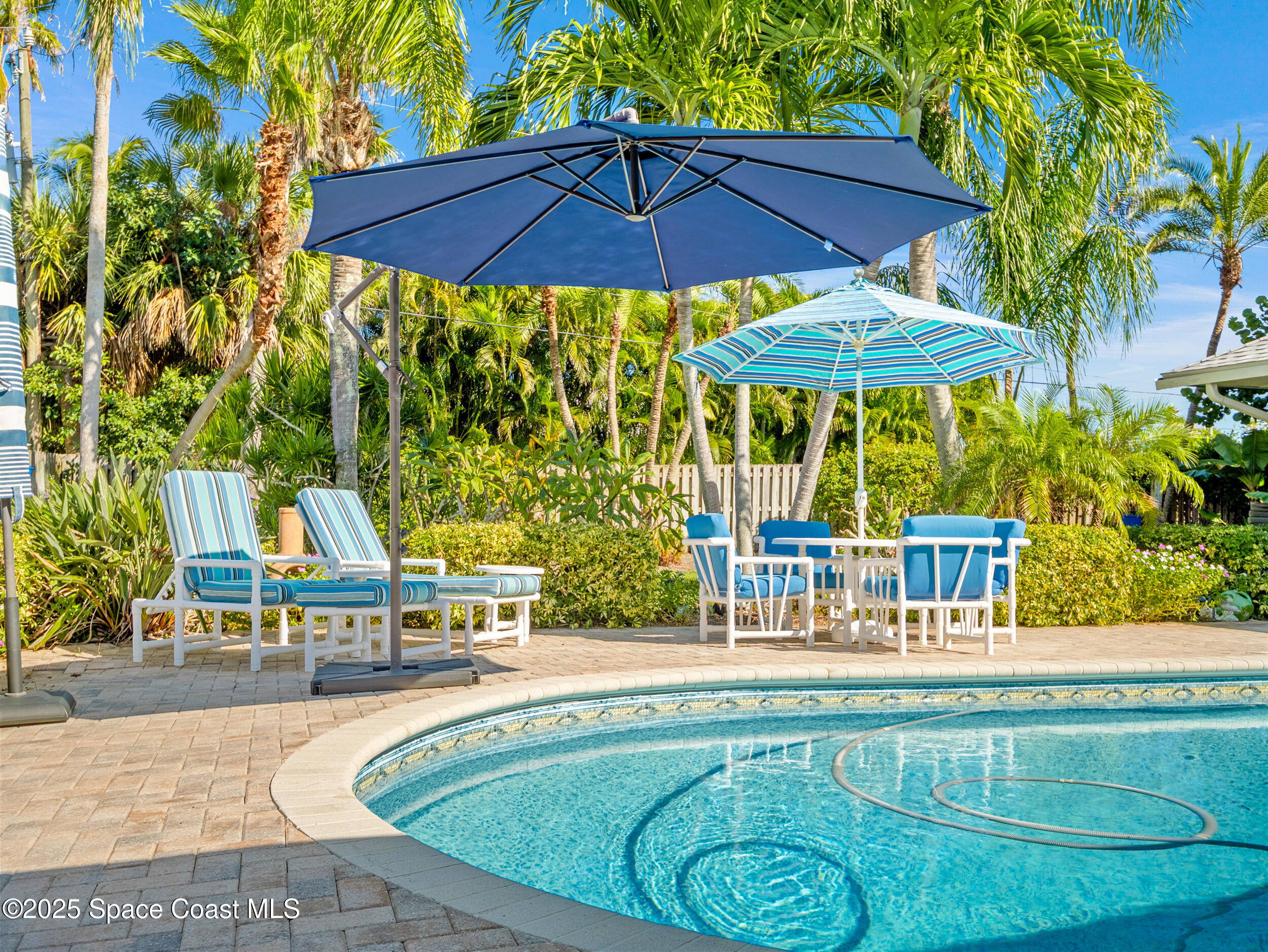 230 Riggs Avenue Melbourne Beach, FL 32951 - Photo 2 of 38 a view of a swimming pool with a patio