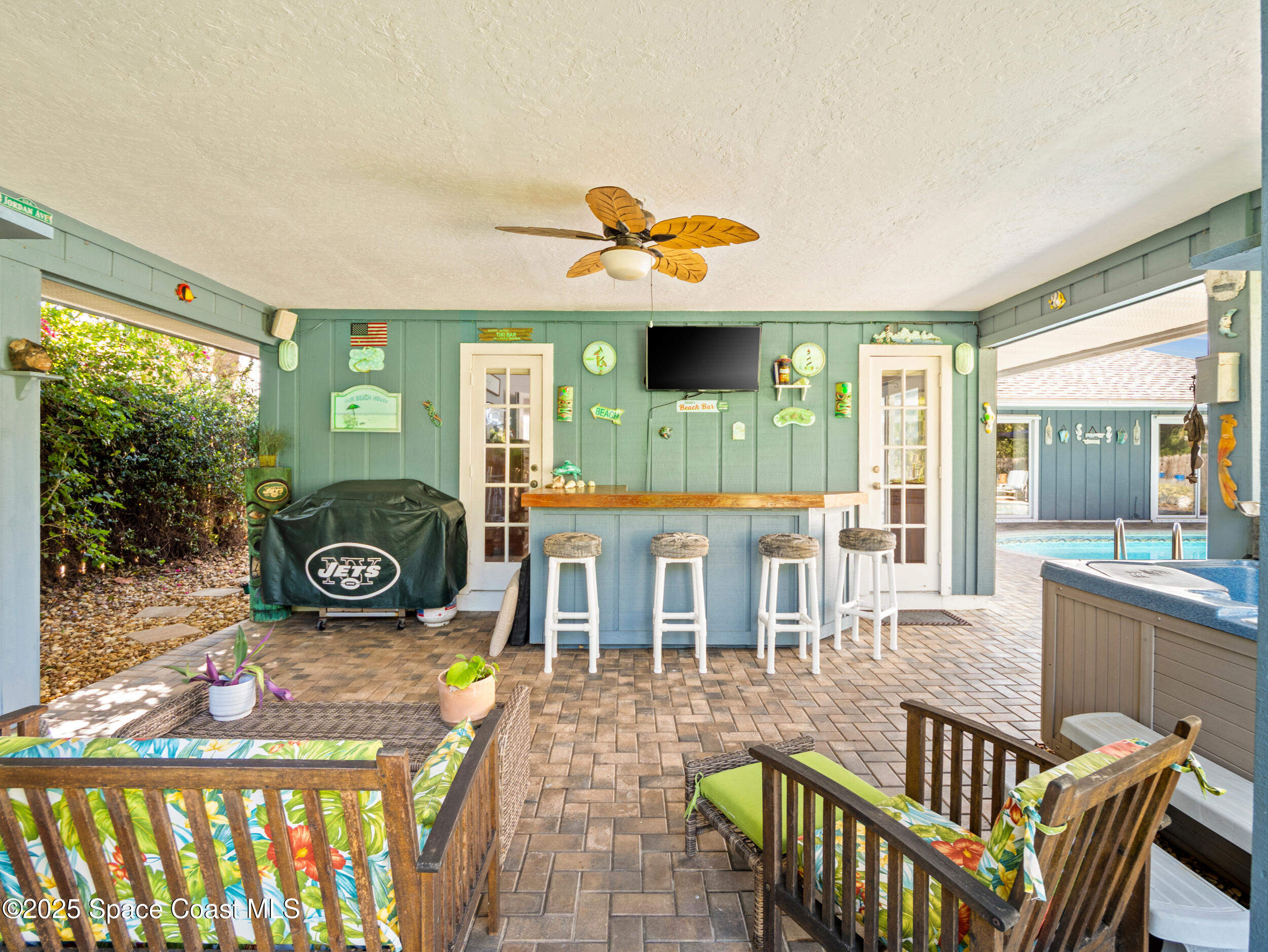 230 Riggs Avenue Melbourne Beach, FL 32951 - Photo 22 of 38 a dining room with furniture a garden and patio