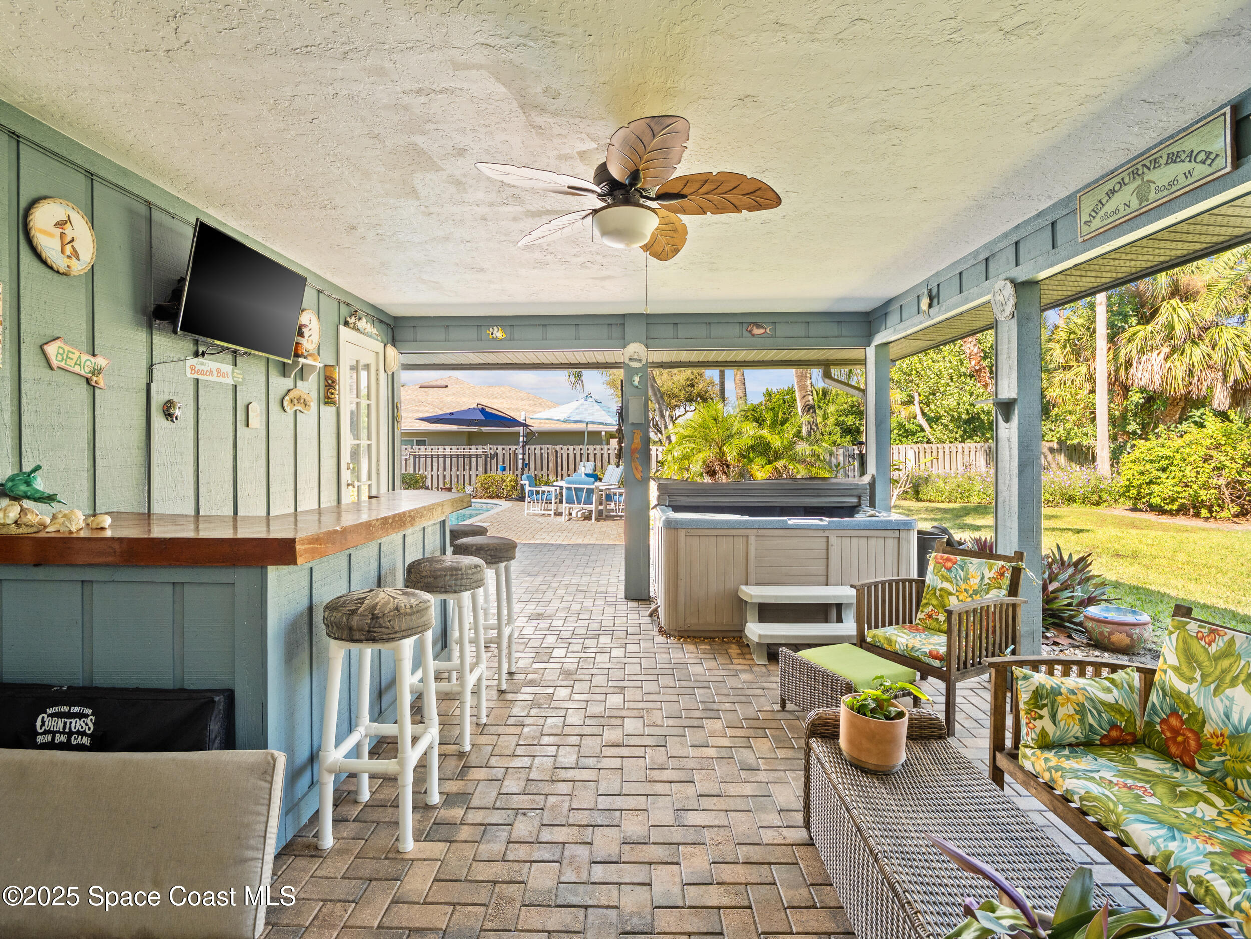 230 Riggs Avenue Melbourne Beach, FL 32951 - Photo 23 of 38 a room with lots of tables a large window and chairs