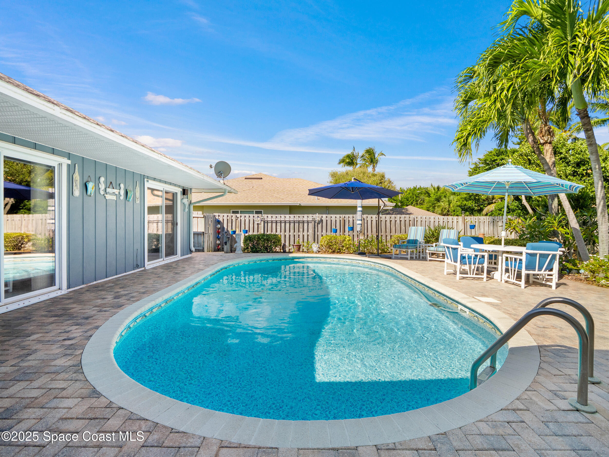 230 Riggs Avenue Melbourne Beach, FL 32951 - Photo 24 of 38 a view of a swimming pool with a lounge chairs