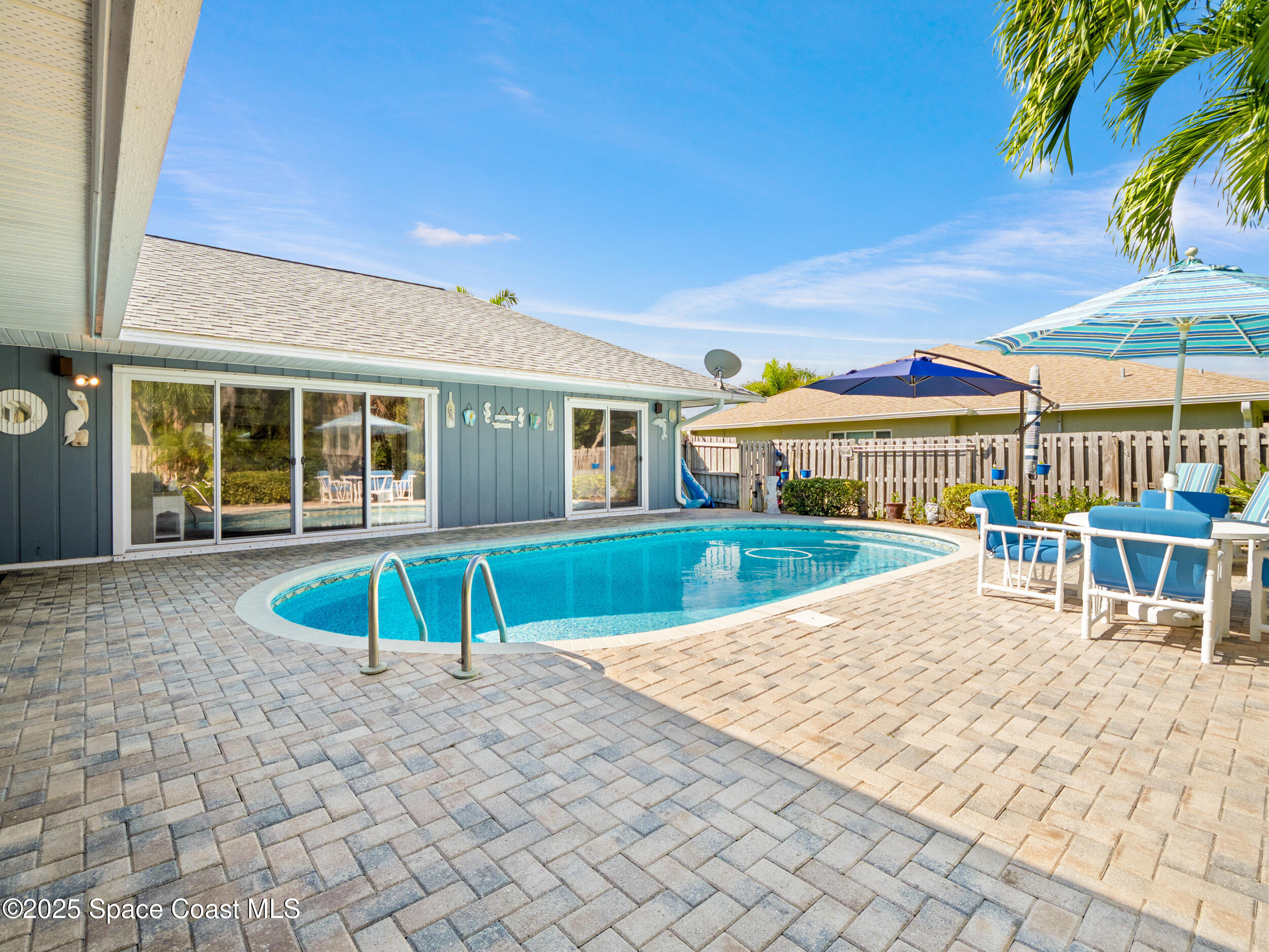230 Riggs Avenue Melbourne Beach, FL 32951 - Photo 25 of 38 front view of a house with a swimming pool