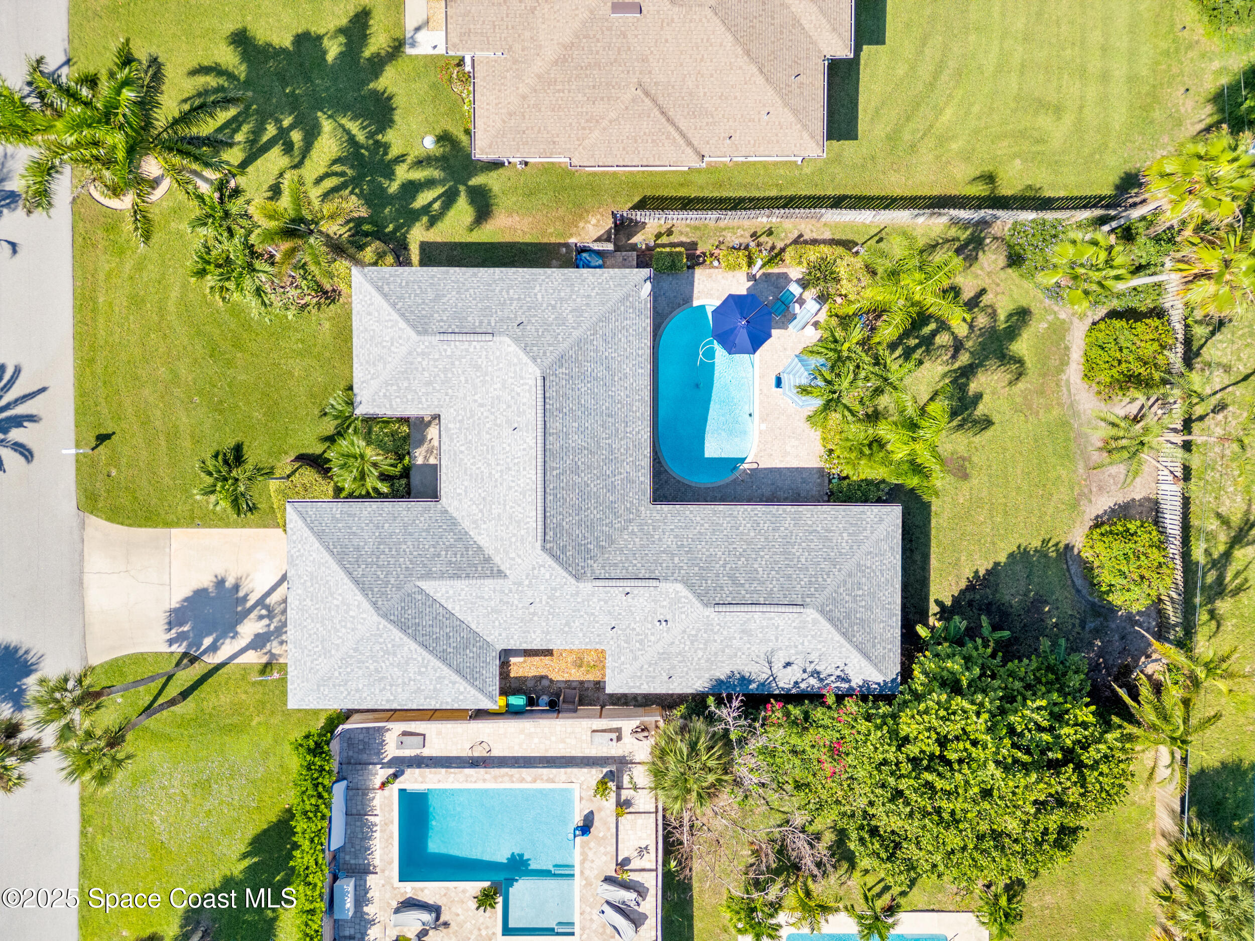 230 Riggs Avenue Melbourne Beach, FL 32951 - Photo 28 of 38 an aerial view of a house with a yard and garden