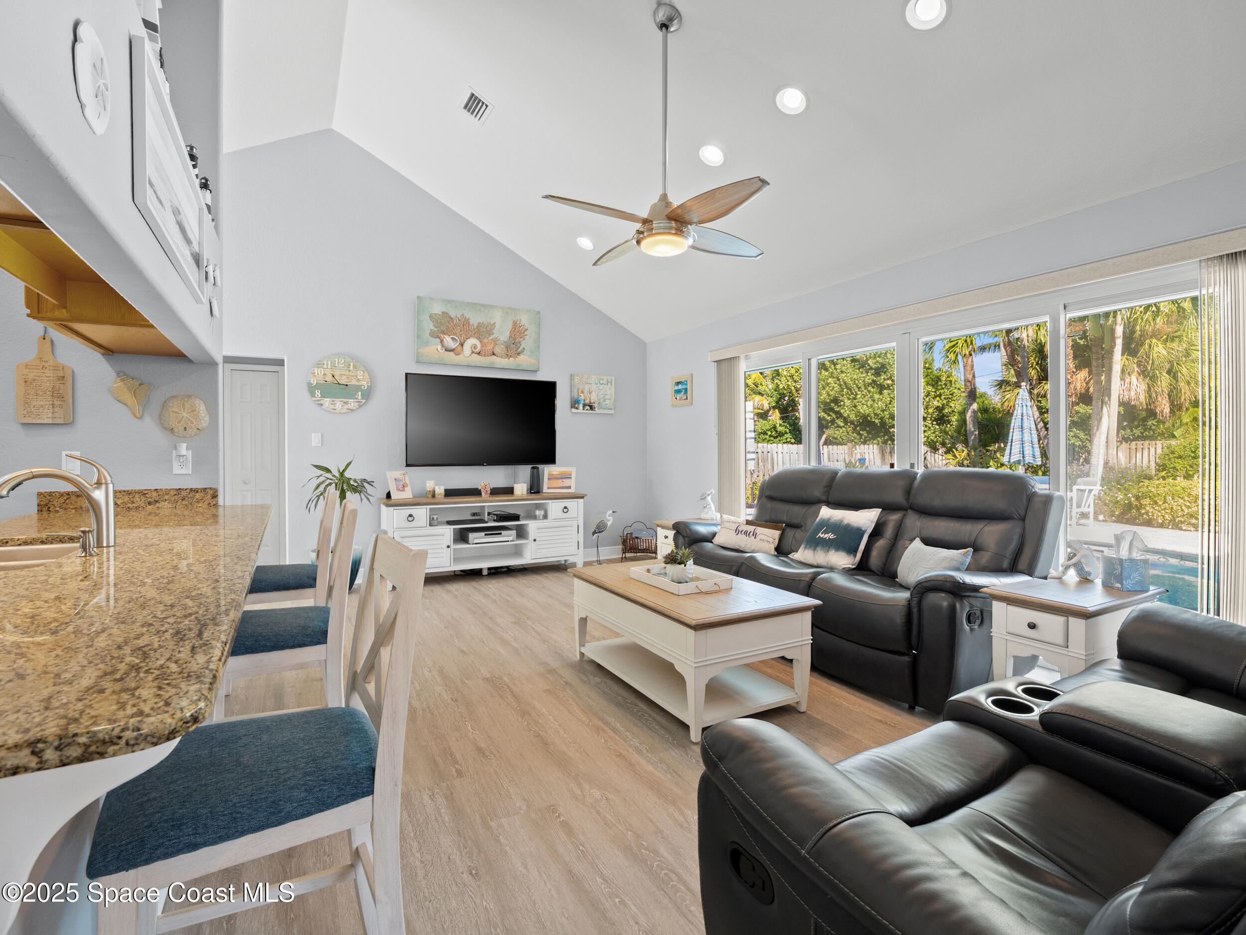 230 Riggs Avenue Melbourne Beach, FL 32951 - Photo 5 of 38 a living room with furniture and a flat screen tv