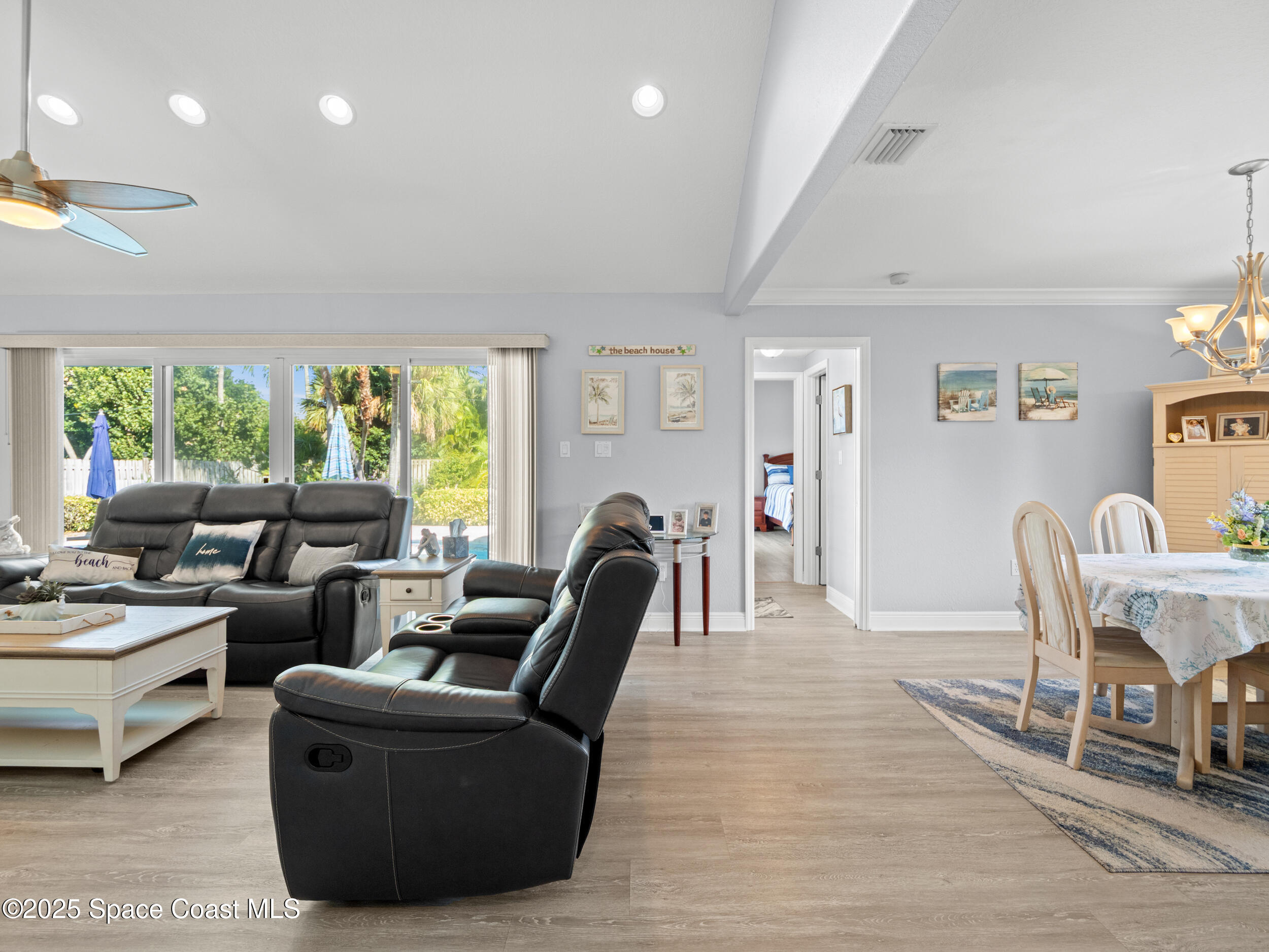 230 Riggs Avenue Melbourne Beach, FL 32951 - Photo 6 of 38 a living room with furniture a window and a bookshelf