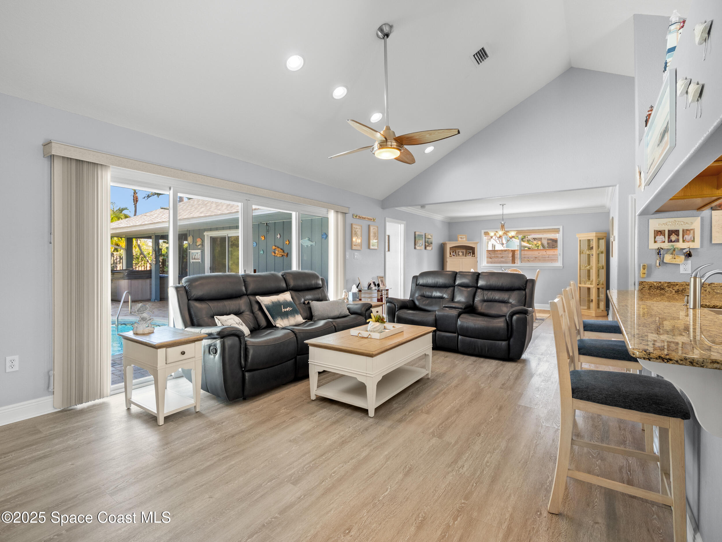 230 Riggs Avenue Melbourne Beach, FL 32951 - Photo 8 of 38 a living room with furniture or outdoor view and a large window