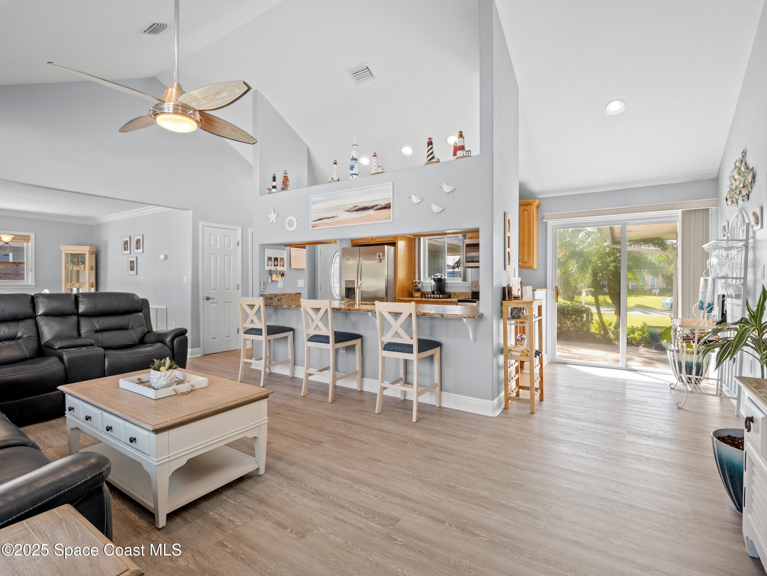 230 Riggs Avenue Melbourne Beach, FL 32951 - Photo 9 of 38 a living room with furniture and a large window