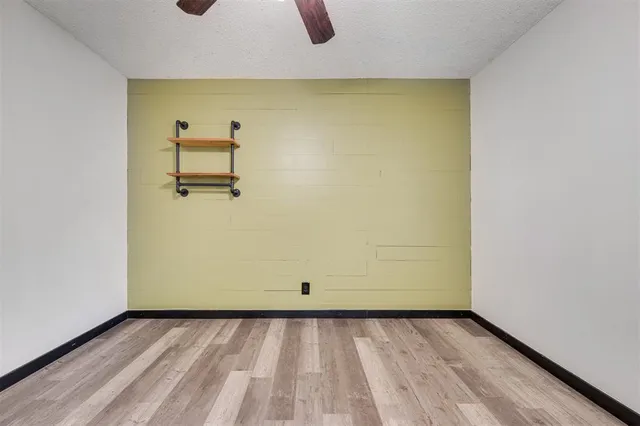 a view of a room with wooden floor