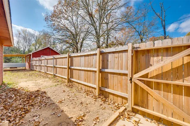 a view of residential house with wooden fence