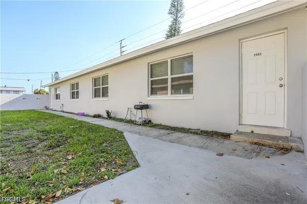 a living room with furniture a flat screen tv and a window