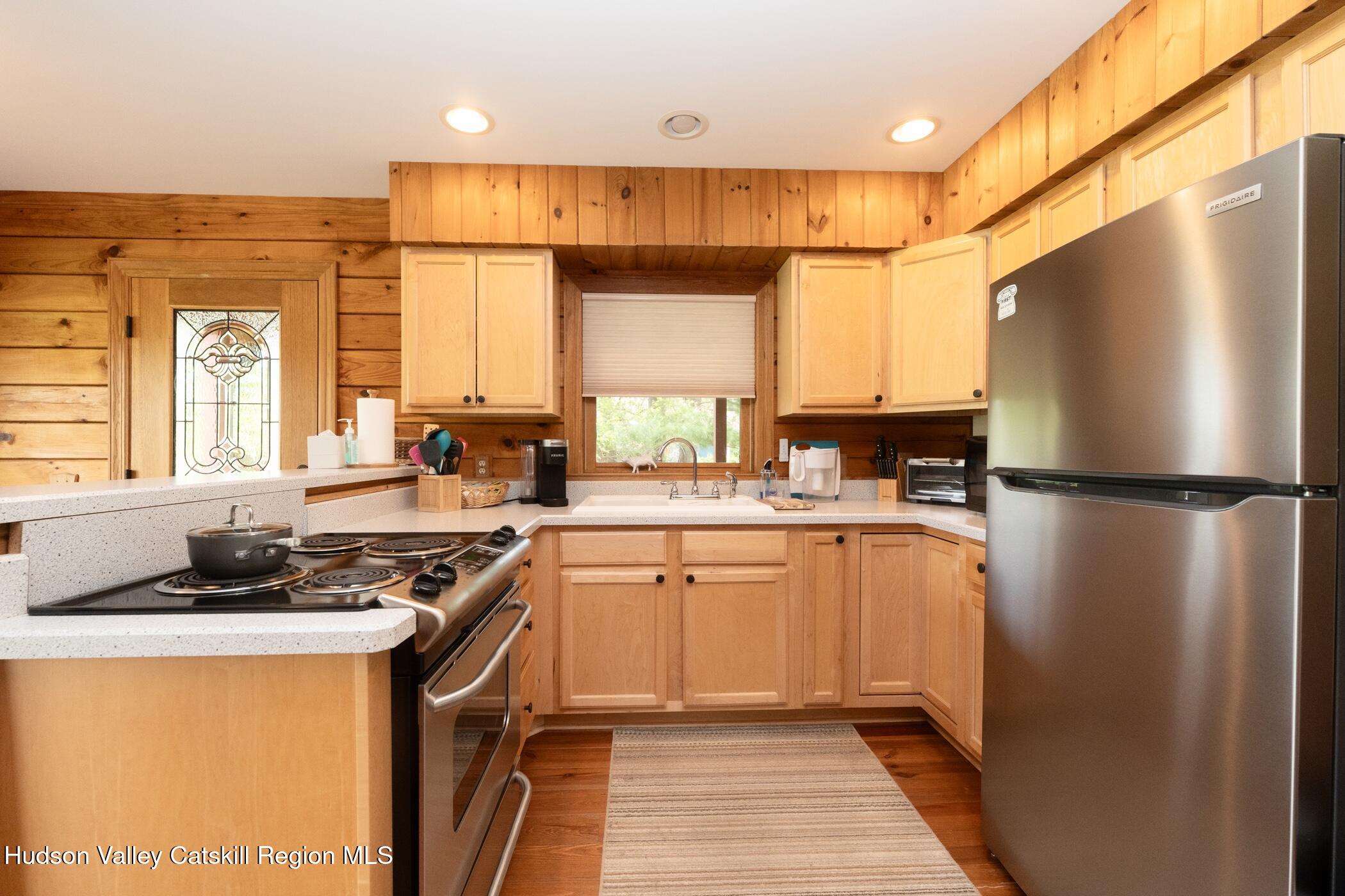 140 Stone Dock Road High Falls, NY 12440 - Photo 12 of 42 a kitchen with a refrigerator a sink and cabinets