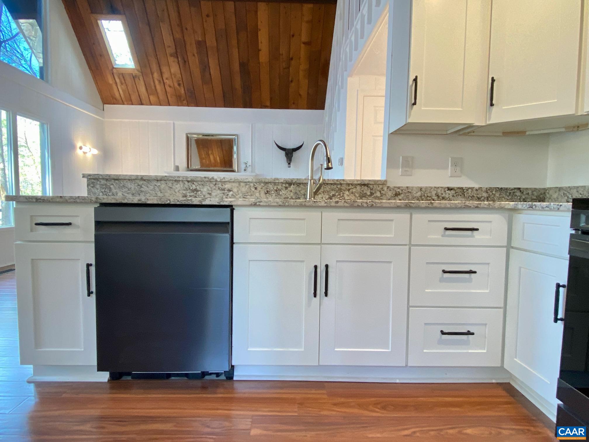 24 Tanglewood Road Palmyra, VA 22963 - Photo 10 of 23 a kitchen with stainless steel appliances granite countertop a sink and cabinets with wooden floor